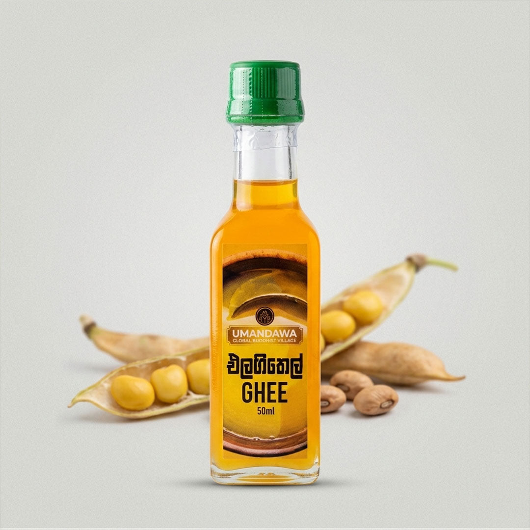50ml bottle of clarified ghee with green cap, pods and seeds in background on white surface