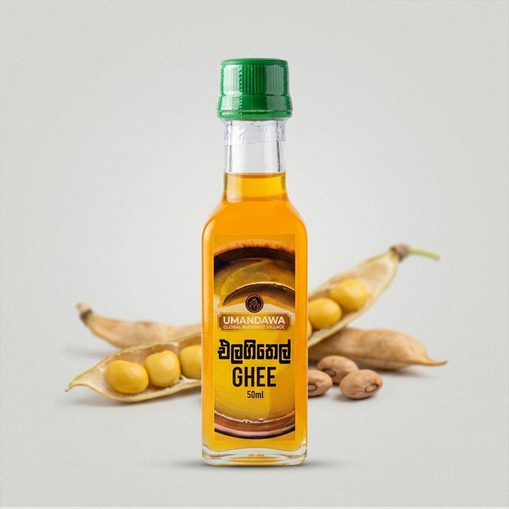 50ml bottle of clarified ghee with green cap, pods and seeds in background on white surface