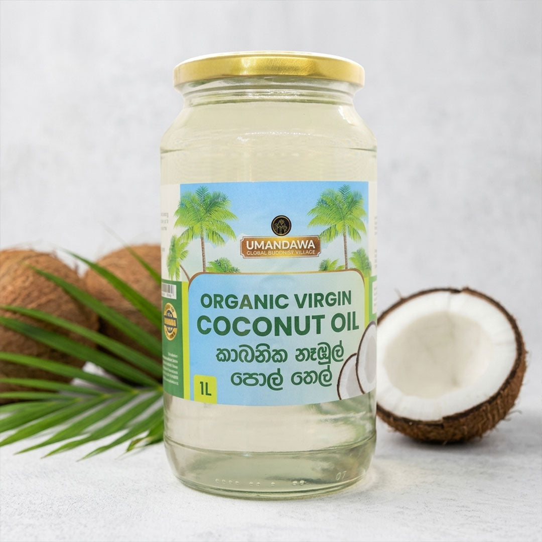 Glass jar of organic virgin coconut oil with whole and halved coconuts on a white surface
