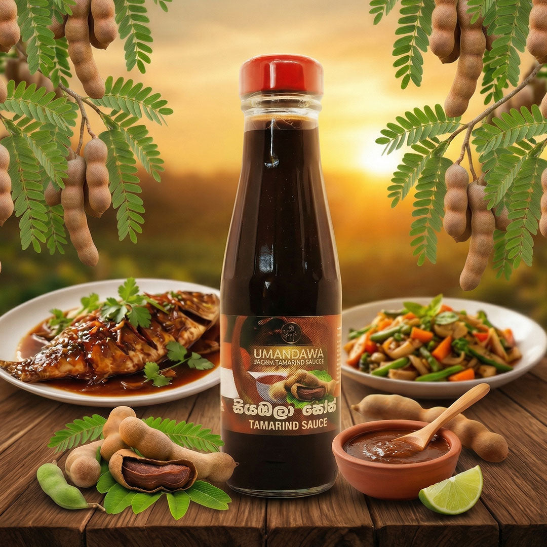 Bottle of tamarind sauce with tamarind pods, cooked fish, vegetables, and sauce on a rustic table